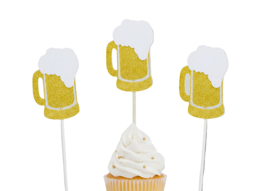 Gold glitter beer mug cupcake toppers displayed on frosted cupcakes for bachelor or 21st birthday party setup.