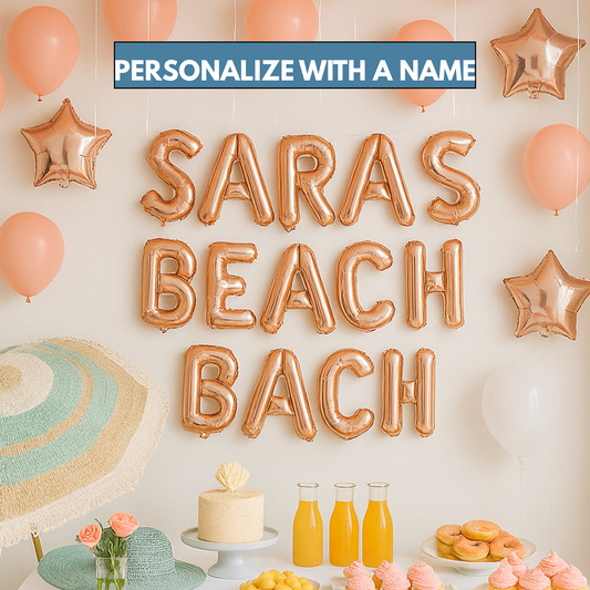 Rose gold foil balloon banner spelling “Beach Bach” at a tropical bachelorette party setup
