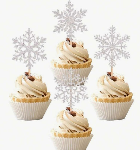 Cupcakes with snowflake decorations on a white background