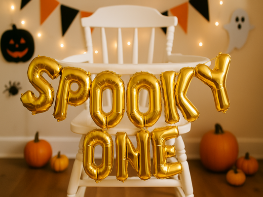Halloween high chair setup with Spooky One balloon decoration