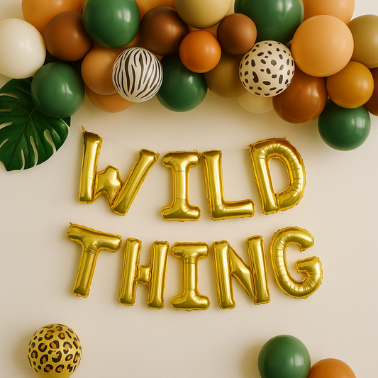 Gold 'WILD THING' balloons surrounded by colorful balloons on a beige background
