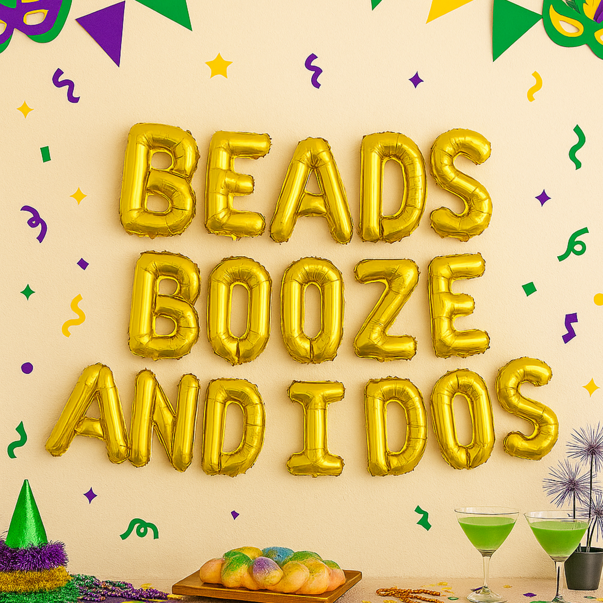 Gold foil balloon banner spelling “Beads Booze and I Dos” above a Mardi Gras-themed party table