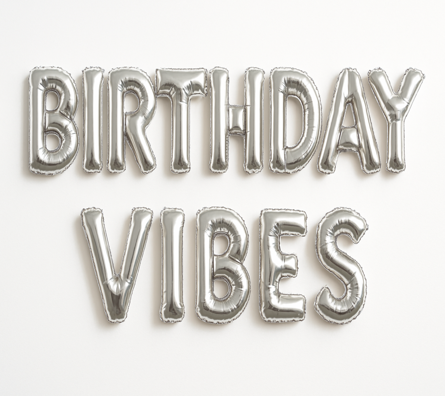 BIRTHDAY VIBES in silver foil letter balloons on white background.