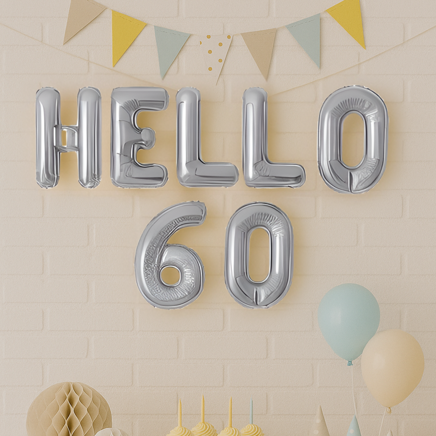 Silver 'HELLO 60' balloons against a beige wall with decorative elements.