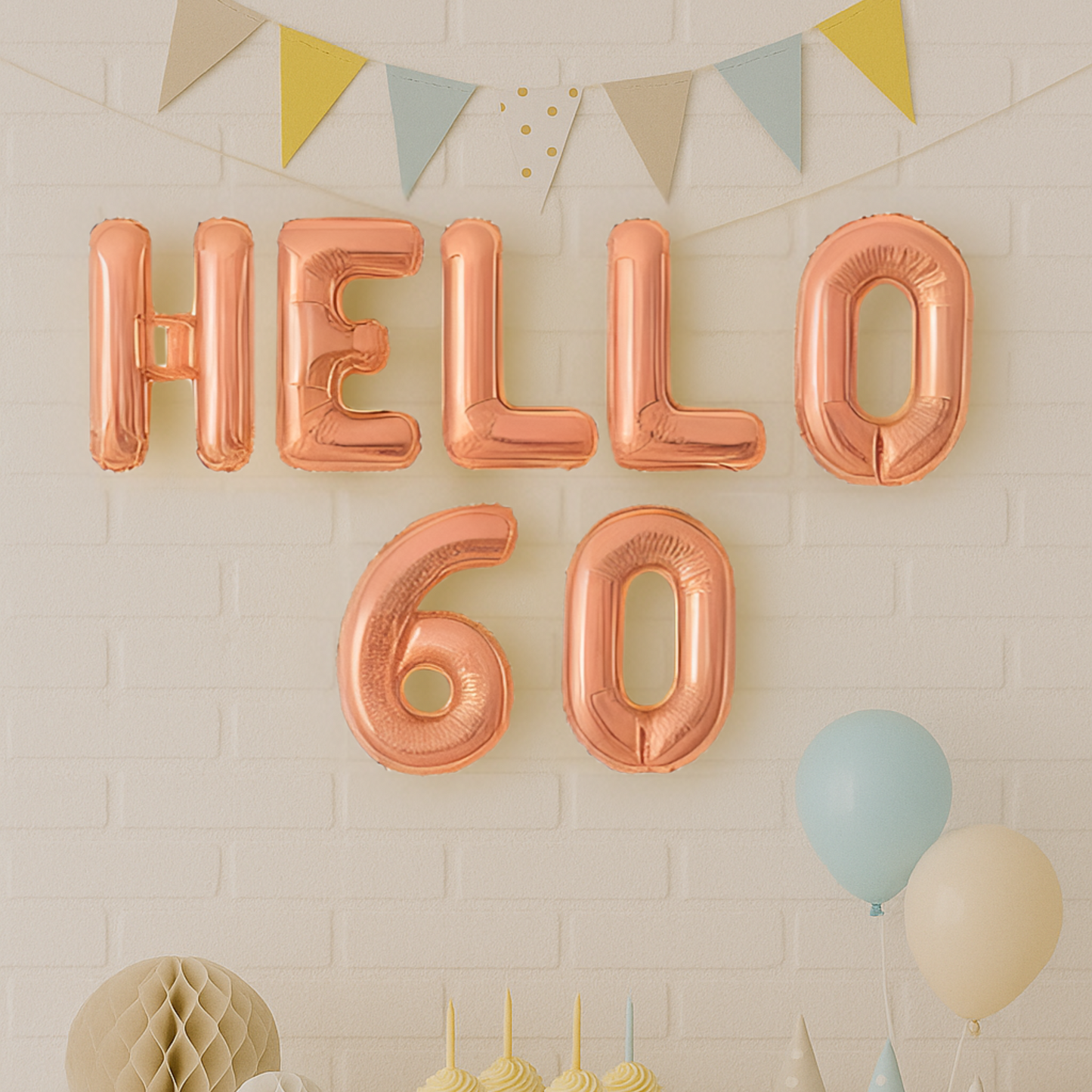 Rose gold 'HELLO 60' balloons against a light brick wall with decorative elements.