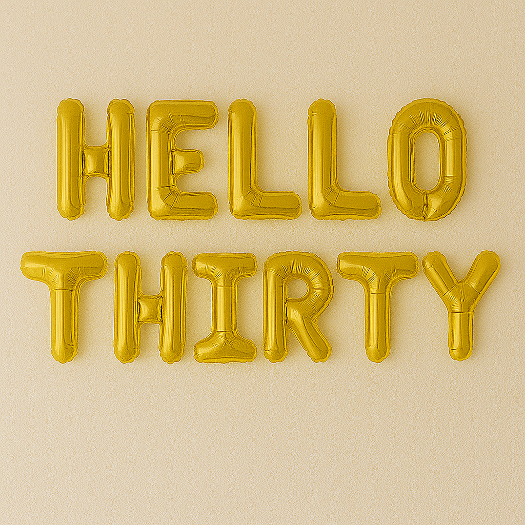 Gold 'HELLO THIRTY' balloons on a beige background