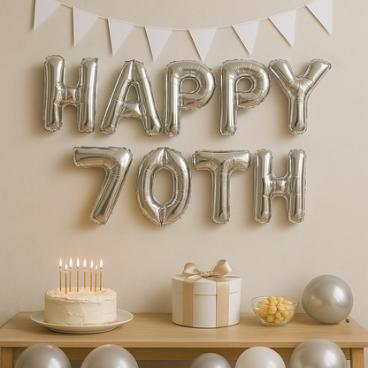 Silver 'HAPPY 70TH' balloons on a wall with a cake, gift, and balloons on a table below.