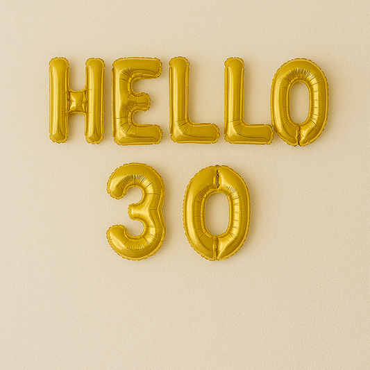 Gold 'HELLO 30' balloons on a beige background