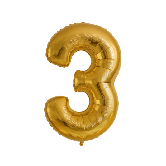 Gold number 3 balloon with colorful balloons and a banner on a light brick wall background