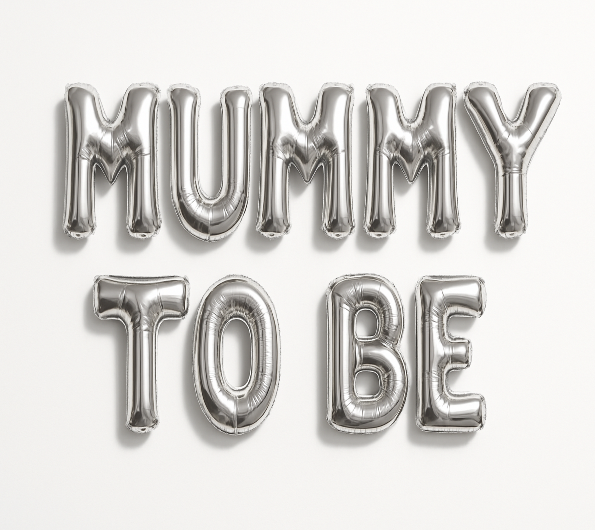Silver 'MUMMY TO BE' balloon letters on a white background