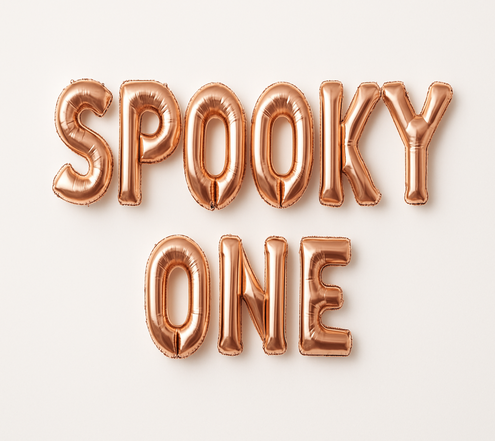 SPOOKY ONE in rose gold foil letter balloons on white background.
