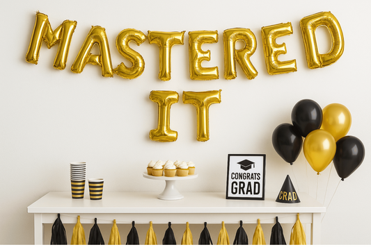 “Gold foil letter balloon banner spelling ‘Mastered It’ for graduation party”