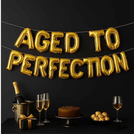 Gold foil balloon banner spelling Aged to Perfection for milestone birthday party