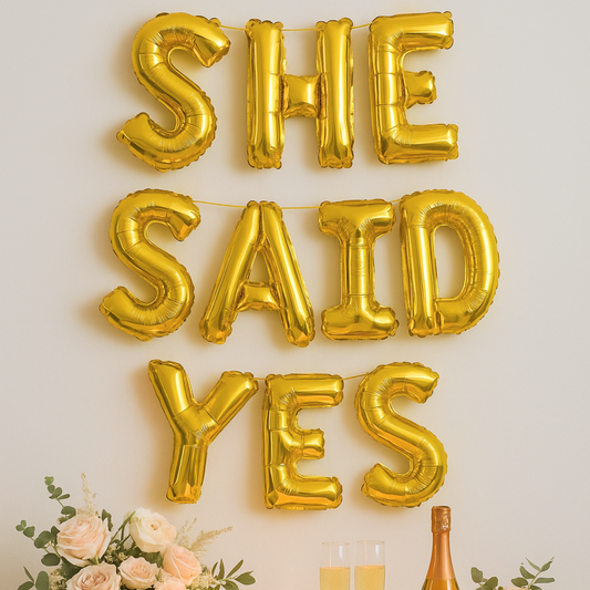 Foil letter balloons spelling She Said Yes for engagement or proposal party decor
