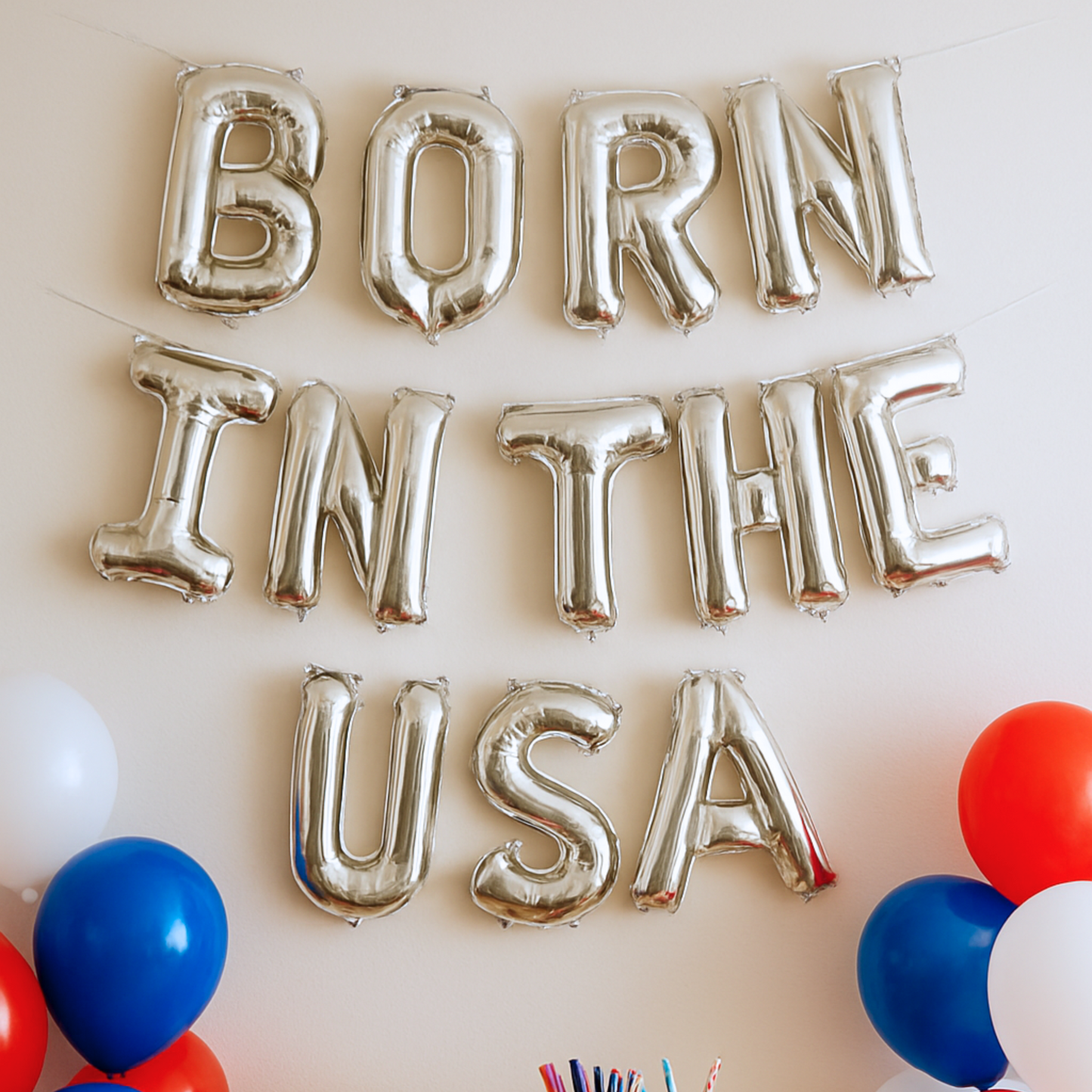 Patriotic-themed party setup featuring 'Born in the USA' balloon banner