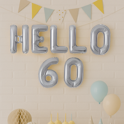 Silver 'HELLO 60' balloons against a beige wall with decorative elements.
