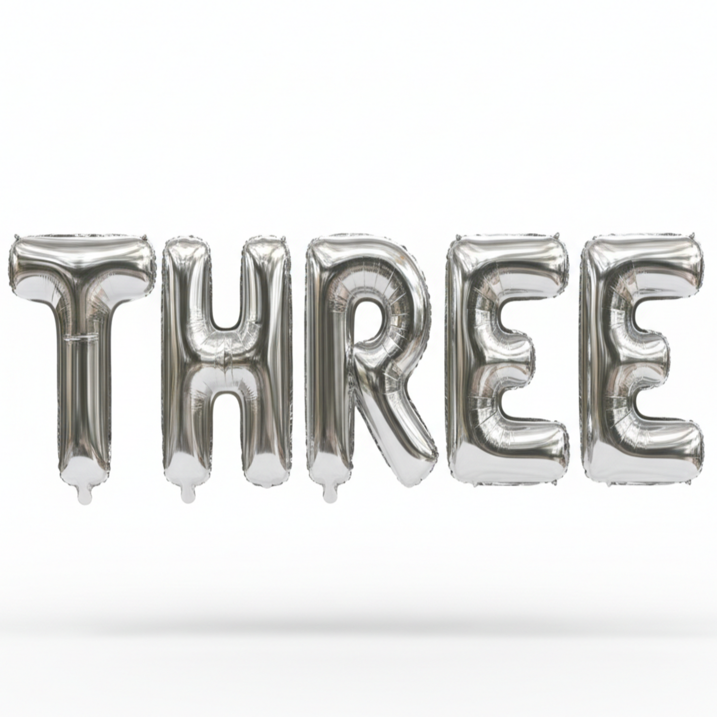 THREE in silver foil letter balloons on white background. All letters should be the same size with no strings.