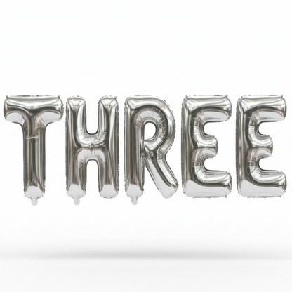 THREE in silver foil letter balloons on white background. All letters should be the same size with no strings.